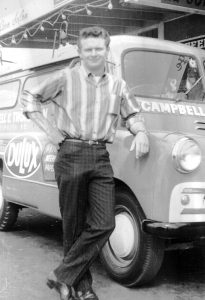 Colin Campbell standing in front of sign-written van